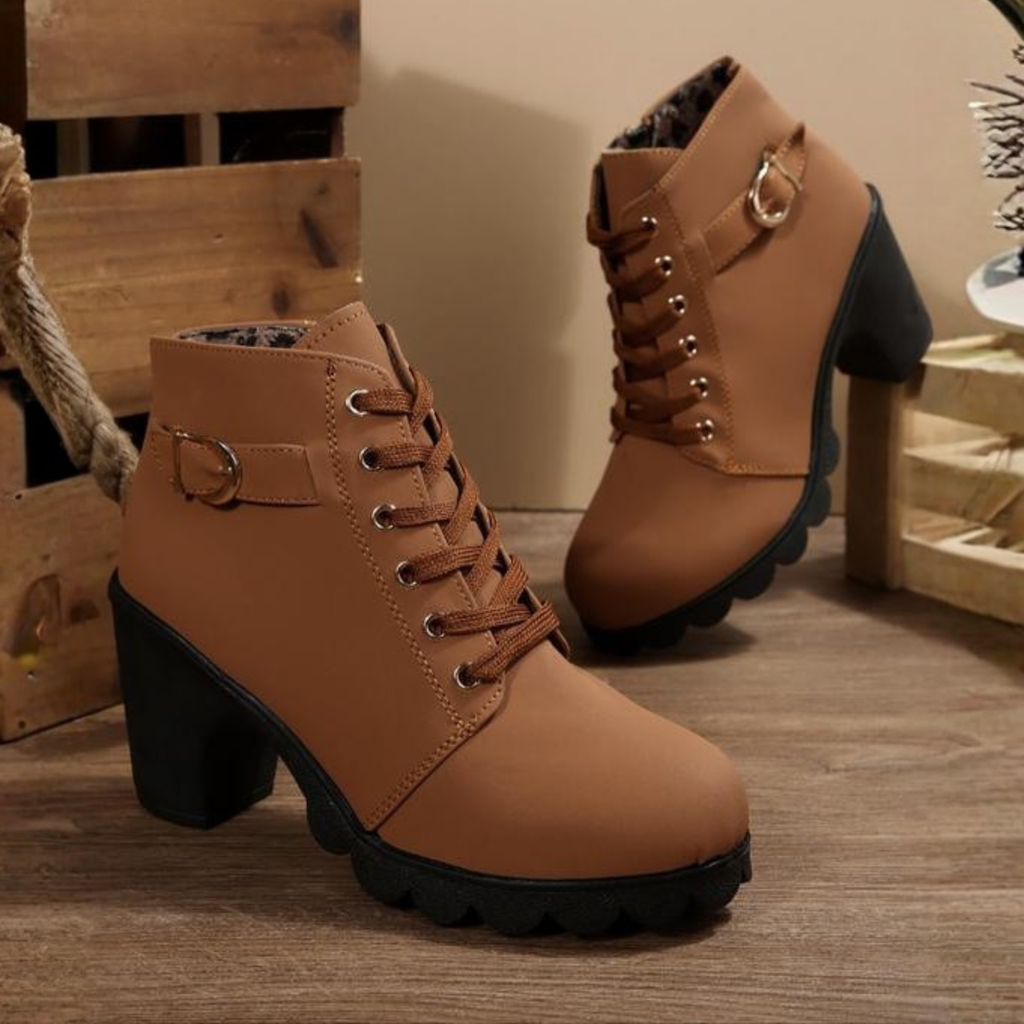 Black ankle boots featuring a lace-up design and metal buckle detail, offering a stylish and edgy look. 1