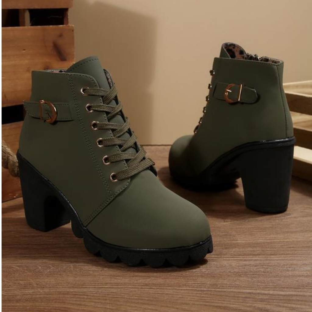 Black ankle boots featuring a lace-up design and metal buckle detail, offering a stylish and edgy look. 2