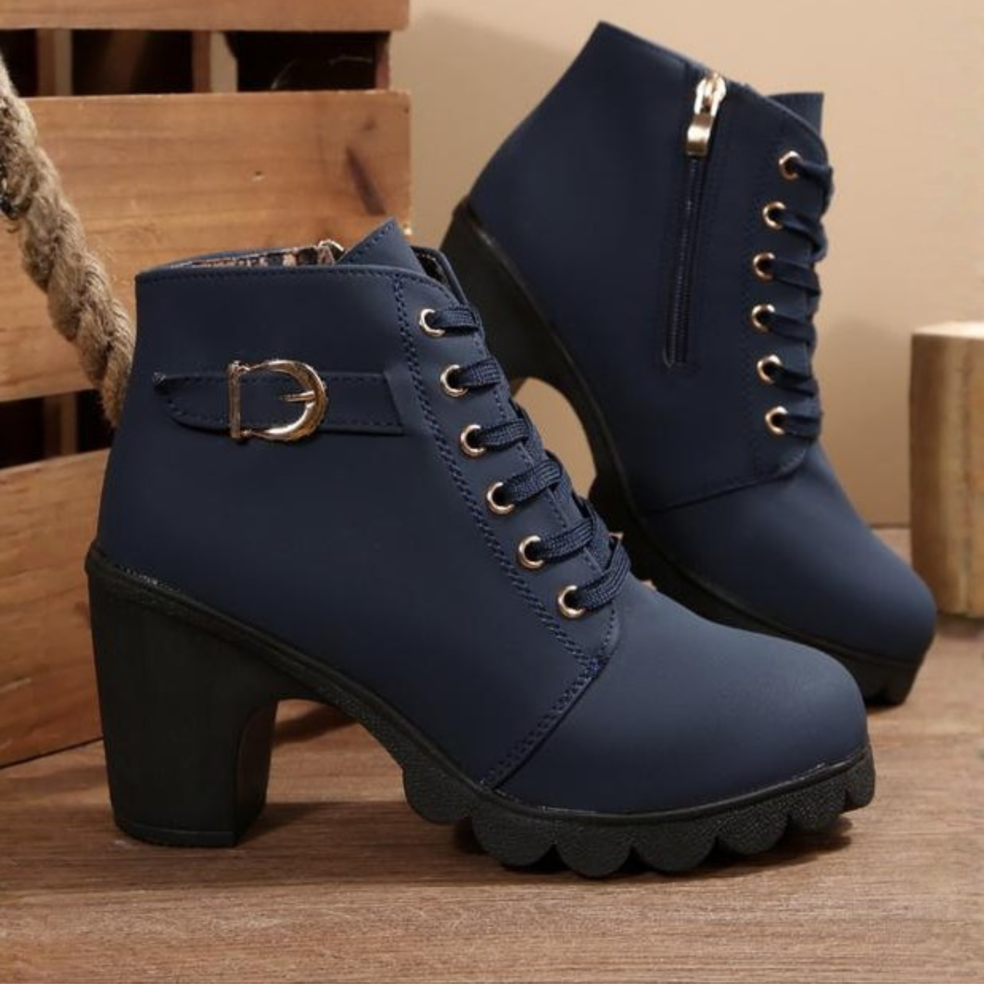 Black ankle boots featuring a lace-up design and metal buckle detail, offering a stylish and edgy look. 3