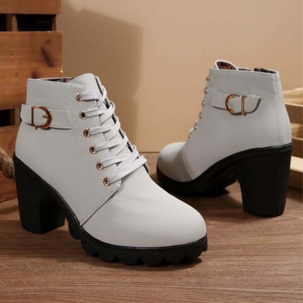 Black ankle boots featuring a lace-up design and metal buckle detail, offering a stylish and edgy look. 4