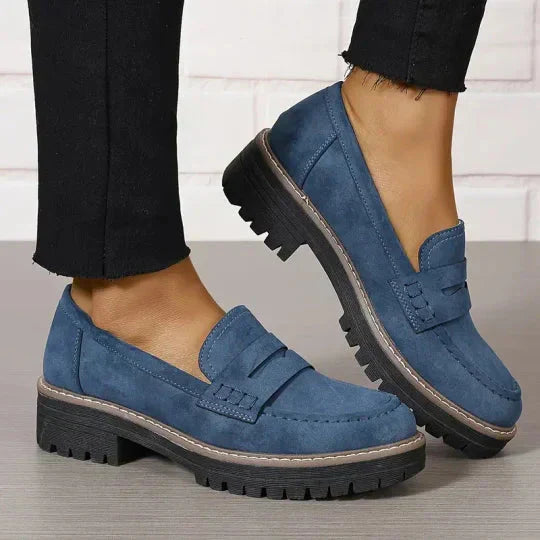 Soft blue moccasins with an ergonomic sole and wedge design, offering a casual and comfortable style. 8