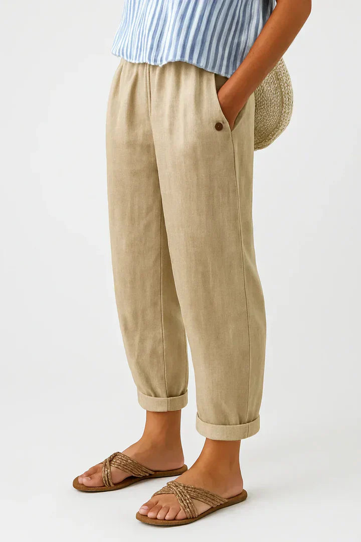 Relaxed cropped trousers in soft beige with an elastic waistband and pockets for comfort and style. 0