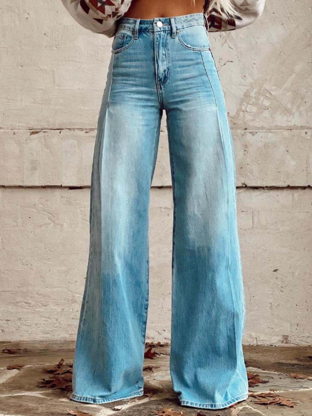 High-waisted, loose-fit wide leg pants in a soft beige, offering a relaxed and effortless look. 0