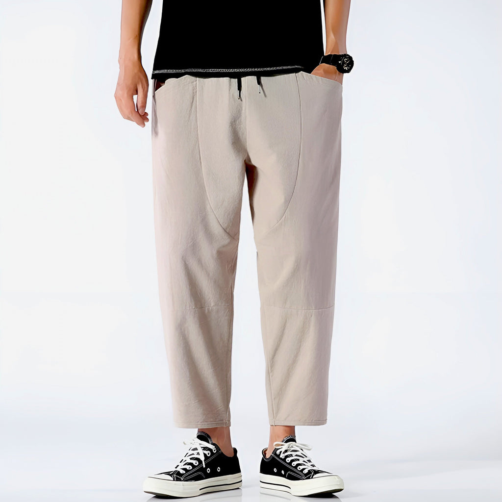 Light beige cropped pants in a relaxed fit, made from a soft cotton-linen blend, featuring a drawstring waist. 2