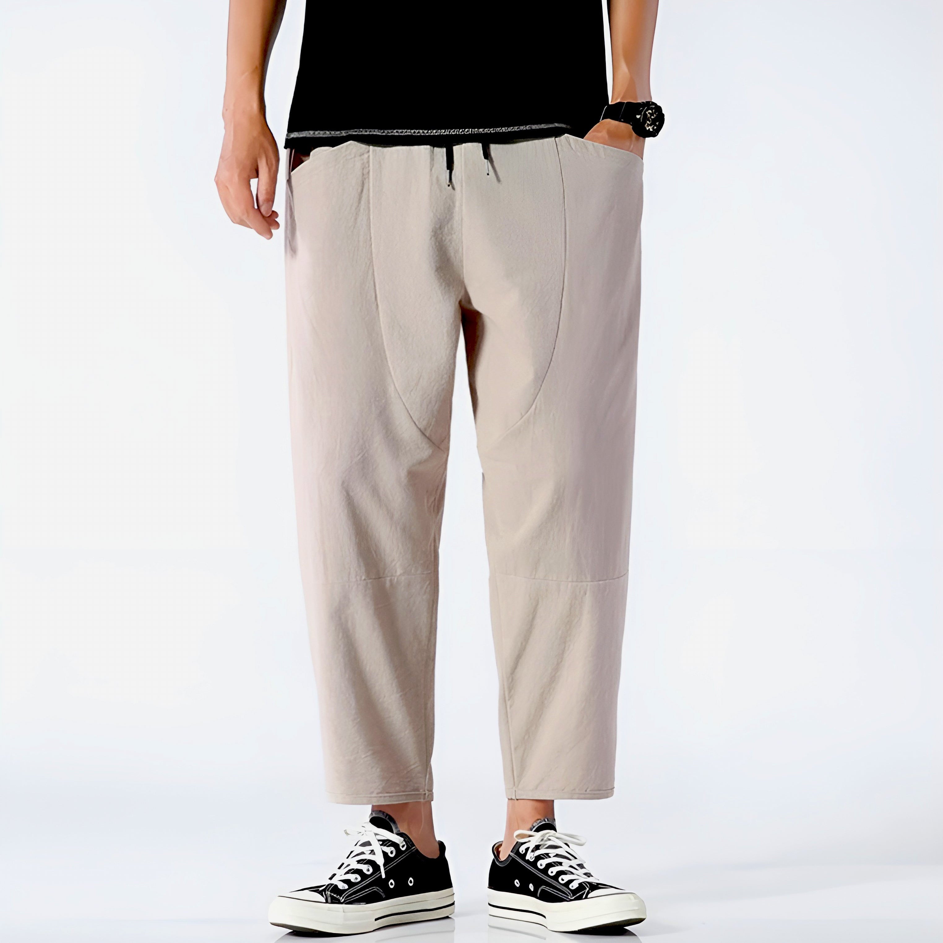 Light beige cropped pants in a relaxed fit, made from a soft cotton-linen blend, featuring a drawstring waist. 2