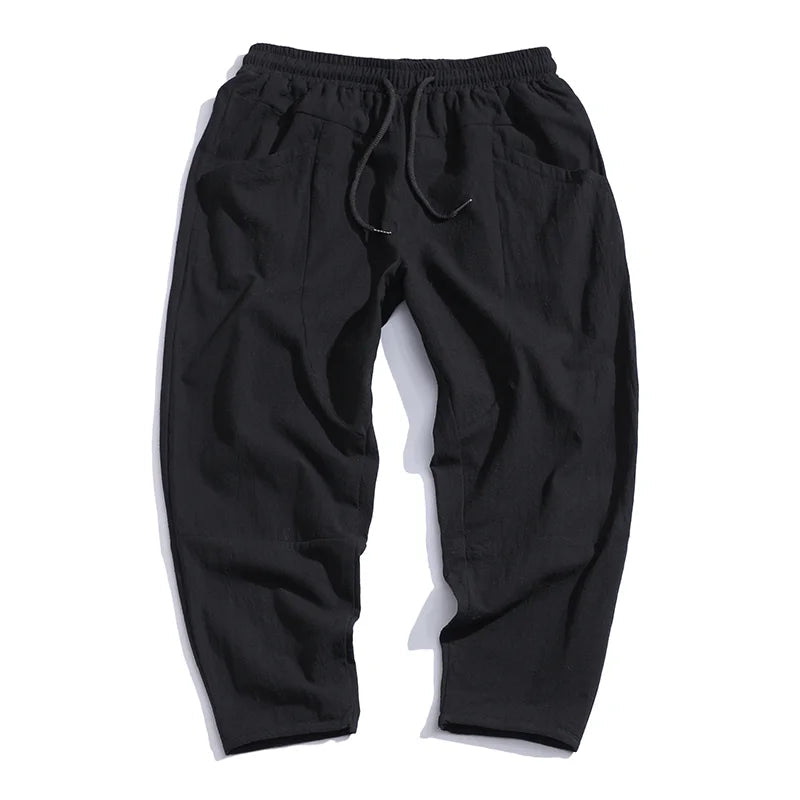 Light beige cropped pants in a relaxed fit, made from a soft cotton-linen blend, featuring a drawstring waist. 7