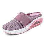 Light grey slip-on mules with a breathable upper and cushioned sole for casual comfort. 1