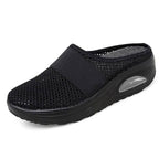 Light grey slip-on mules with a breathable upper and cushioned sole for casual comfort. 2