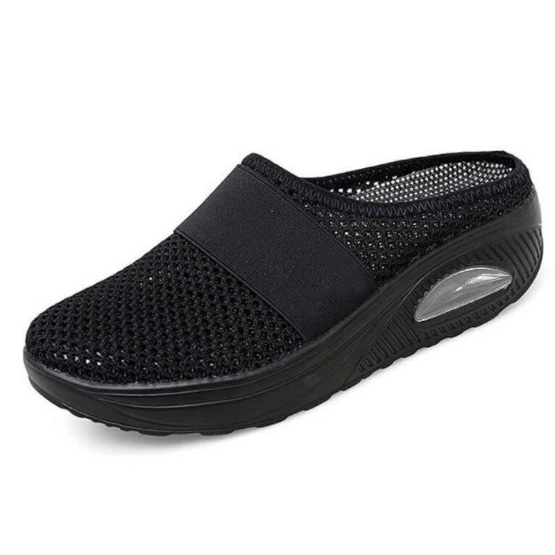 Light grey slip-on mules with a breathable upper and cushioned sole for casual comfort. 2