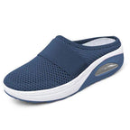 Light grey slip-on mules with a breathable upper and cushioned sole for casual comfort. 4