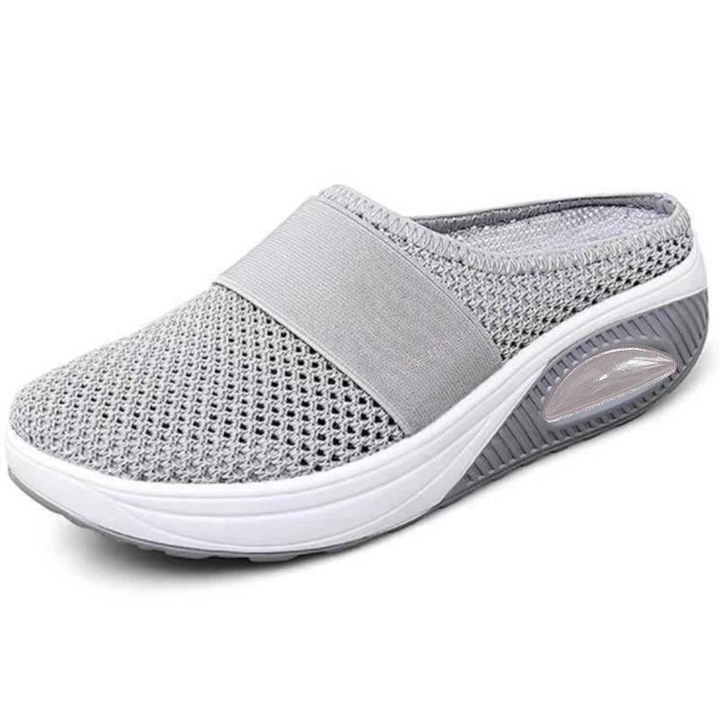 Light grey slip-on mules with a breathable upper and cushioned sole for casual comfort. 5