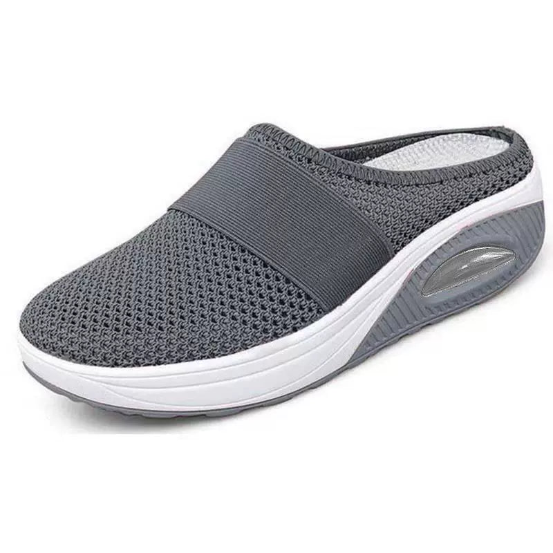 Light grey slip-on mules with a breathable upper and cushioned sole for casual comfort. 6