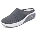 Light grey slip-on mules with a breathable upper and cushioned sole for casual comfort. 6