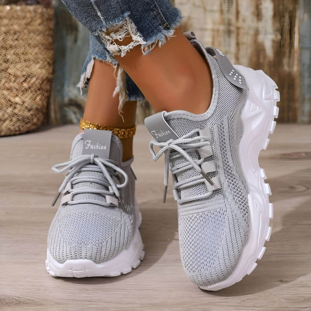 Light gray orthopedic sneakers with a roomy toe box and cushioned sole, featuring a casual and comfortable style. 7