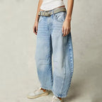 Light blue wide-leg jeans with a relaxed fit, featuring a classic five-pocket style and frayed hem. 11