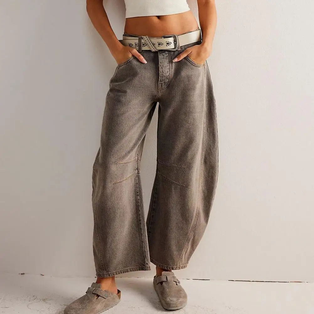 Light blue wide-leg jeans with a relaxed fit, featuring a classic five-pocket style and frayed hem. 12