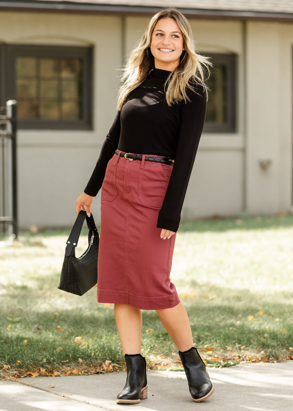Black cotton twill midi skirt, stretchy and semi-fitted style for a comfortable and sleek look. 5
