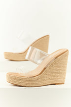 Beige espadrille wedge heels featuring clear lucite straps in a modern, summery style. 1