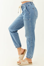 High-rise blue jogger jeans with a drawstring and pockets, featuring a relaxed fit and casual style. 4