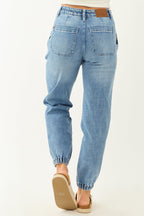High-rise blue jogger jeans with a drawstring and pockets, featuring a relaxed fit and casual style. 6