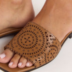 Tan leather sandals with a soft square toe and intricate laser-cut pattern. 1