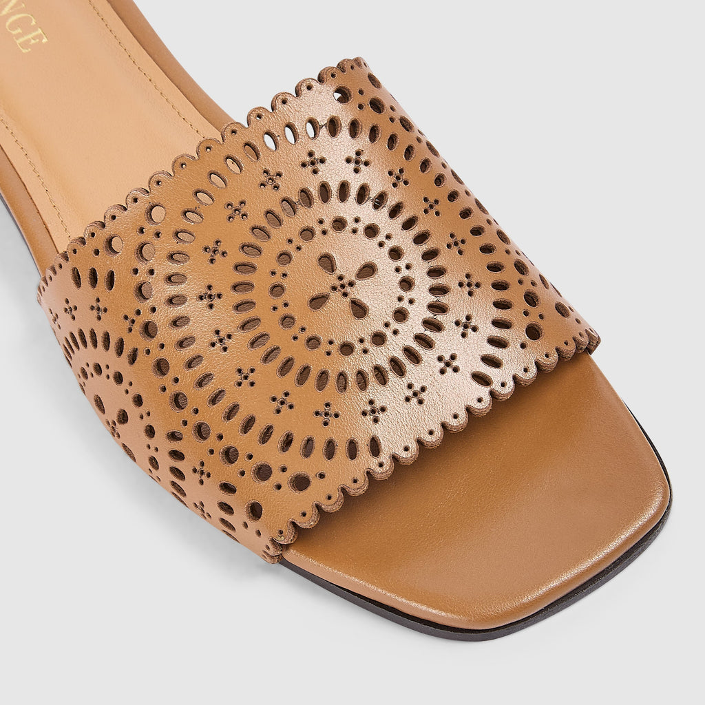 Tan leather sandals with a soft square toe and intricate laser-cut pattern. 5