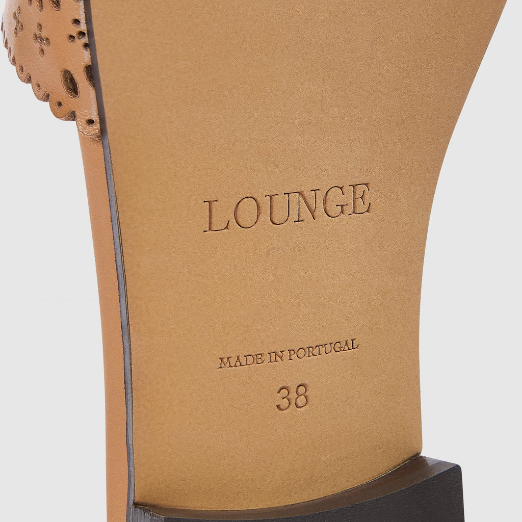 Tan leather sandals with a soft square toe and intricate laser-cut pattern. 6