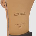 Tan leather sandals with a soft square toe and intricate laser-cut pattern. 6