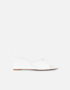Iris wedge mules in a soft beige color with a simple, contemporary design. 1