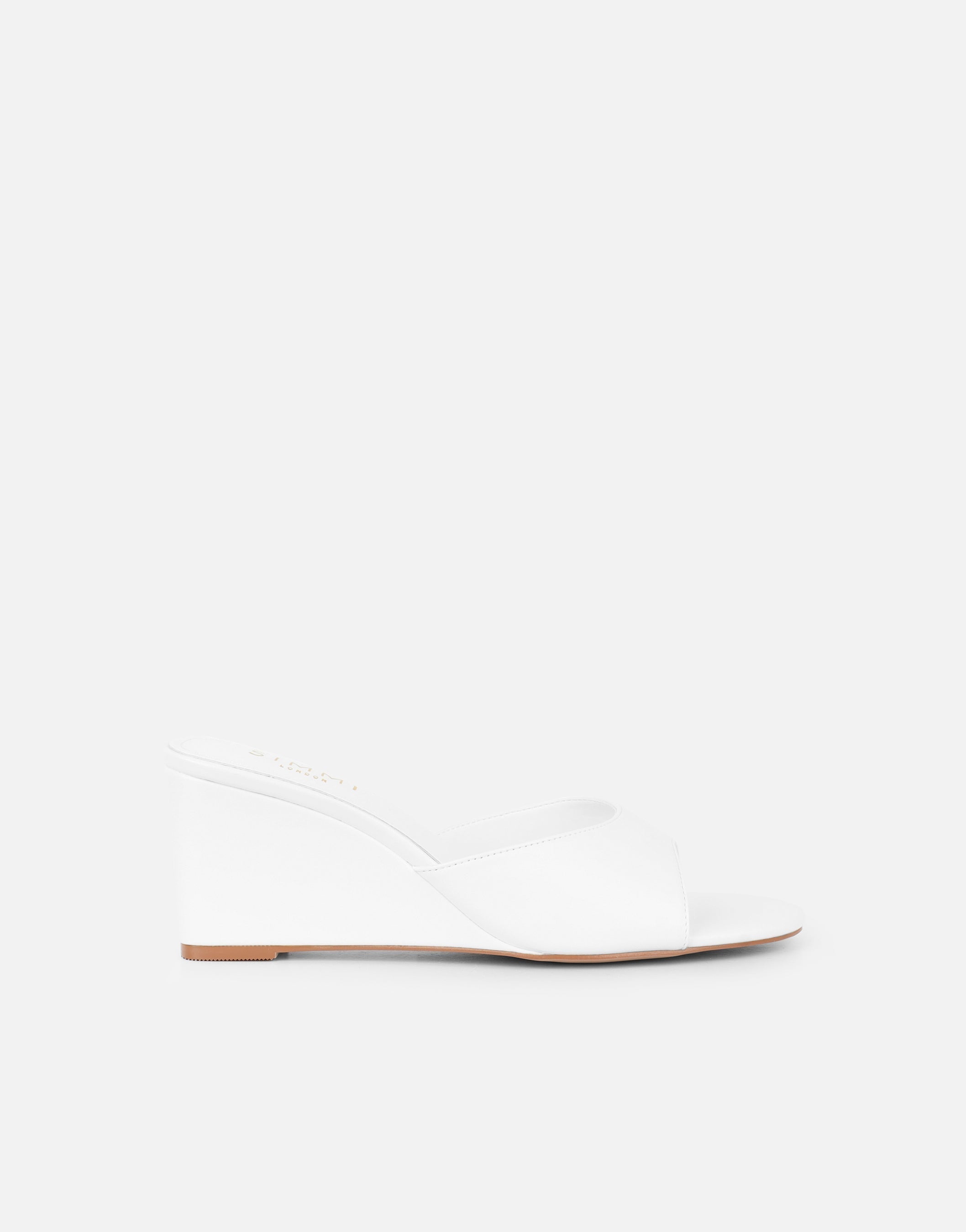 Iris wedge mules in a soft beige color with a simple, contemporary design. 1