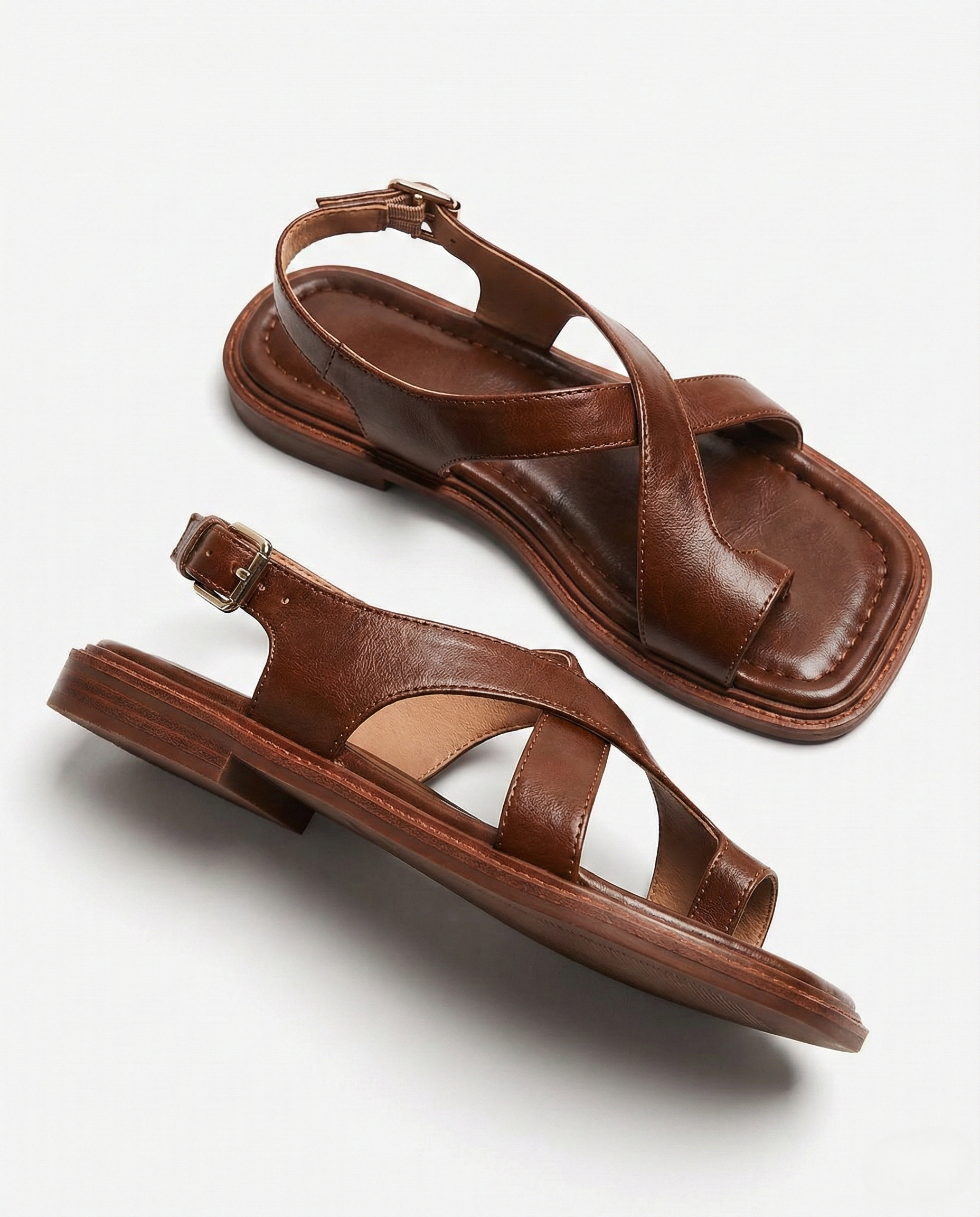 Brown leather cross sandals with a casual style, featuring a simple yet elegant design for everyday wear. 2