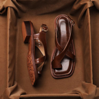 Brown leather cross sandals with a casual style, featuring a simple yet elegant design for everyday wear. 4