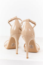 Nude faux leather high heels with an ankle strap, featuring a sleek and comfortable design. 2