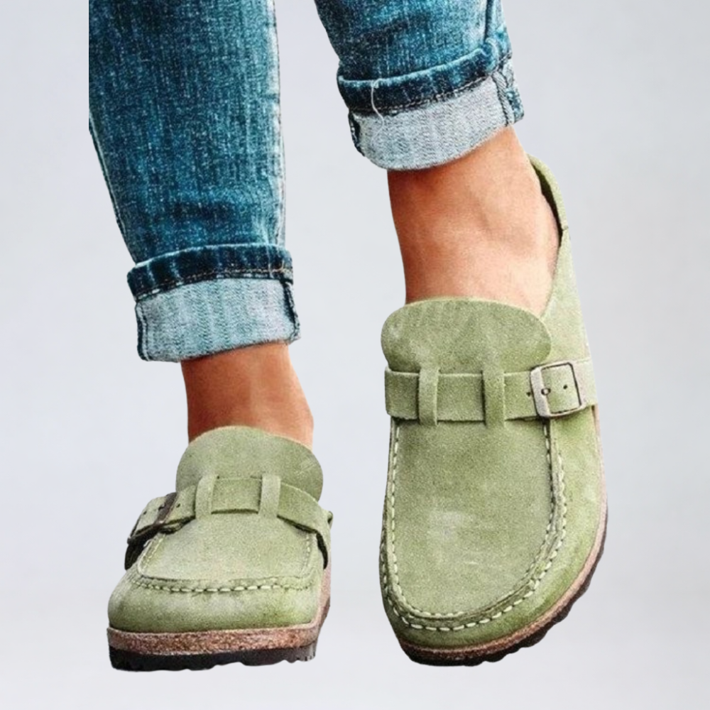 Brown suede clogs with a buckle and adjustable strap, featuring a comfortable and casual style. 0