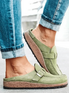 Brown suede clogs with a buckle and adjustable strap, featuring a comfortable and casual style. 2