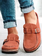 Brown suede clogs with a buckle and adjustable strap, featuring a comfortable and casual style. 3