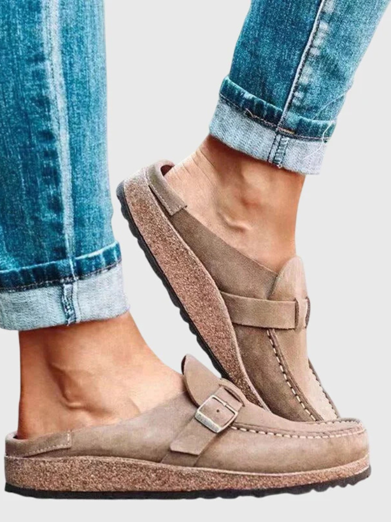 Brown suede clogs with a buckle and adjustable strap, featuring a comfortable and casual style. 6
