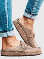 Brown suede clogs with a buckle and adjustable strap, featuring a comfortable and casual style. 6