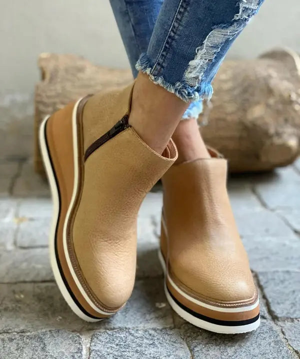 Black suede wedge ankle boots with a sleek, modern design and a subtle pointed toe. 0