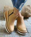 Black suede wedge ankle boots with a sleek, modern design and a subtle pointed toe. 0