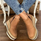 Black suede wedge ankle boots with a sleek, modern design and a subtle pointed toe. 1