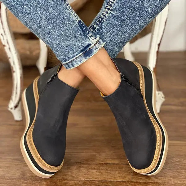 Black suede wedge ankle boots with a sleek, modern design and a subtle pointed toe. 2