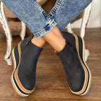 Black suede wedge ankle boots with a sleek, modern design and a subtle pointed toe. 2