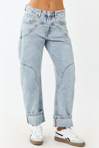 Light wash blue high-rise cuffed barrel baggy jeans with a relaxed fit. 1