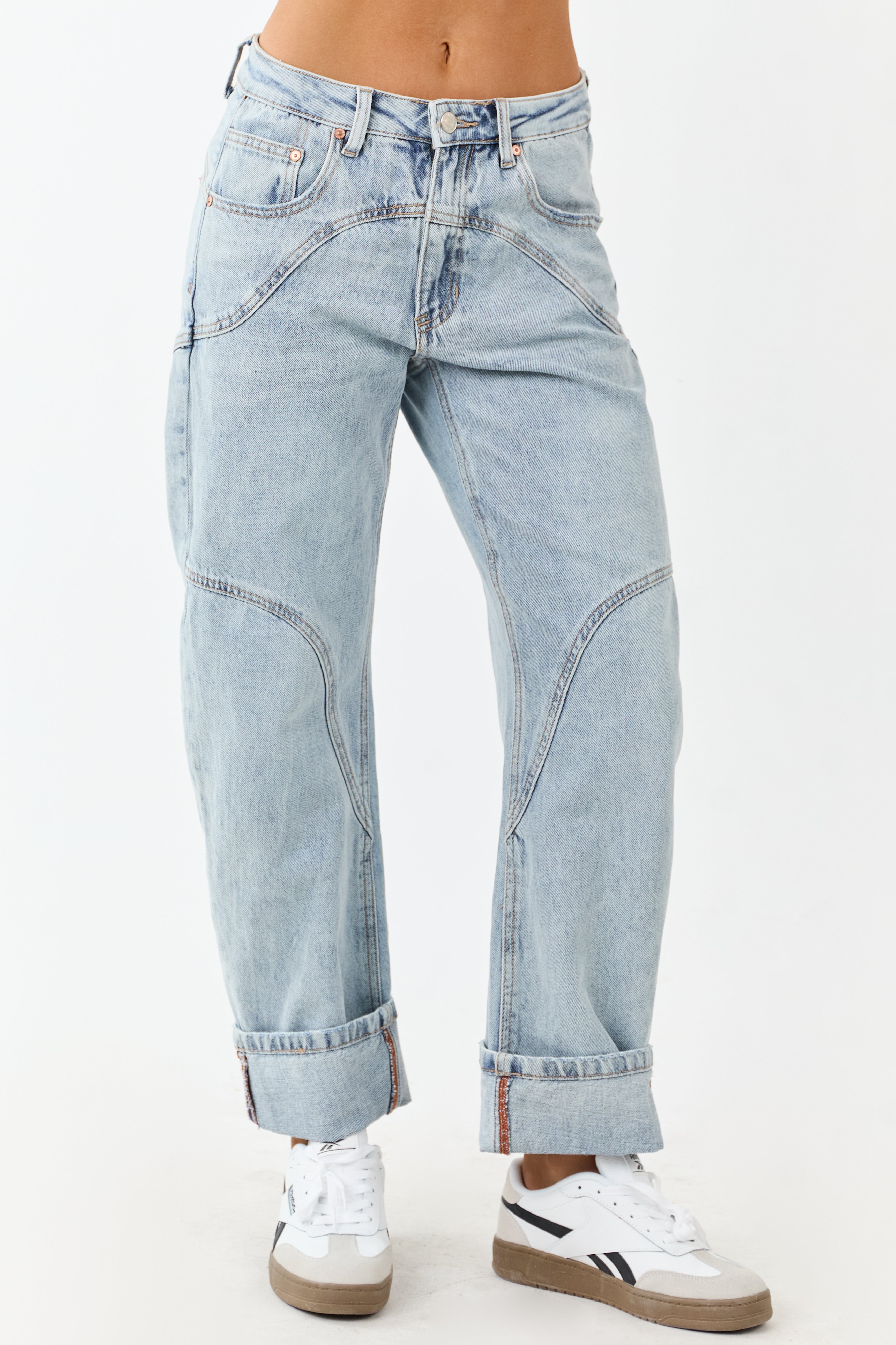 Light wash blue high-rise cuffed barrel baggy jeans with a relaxed fit. 1