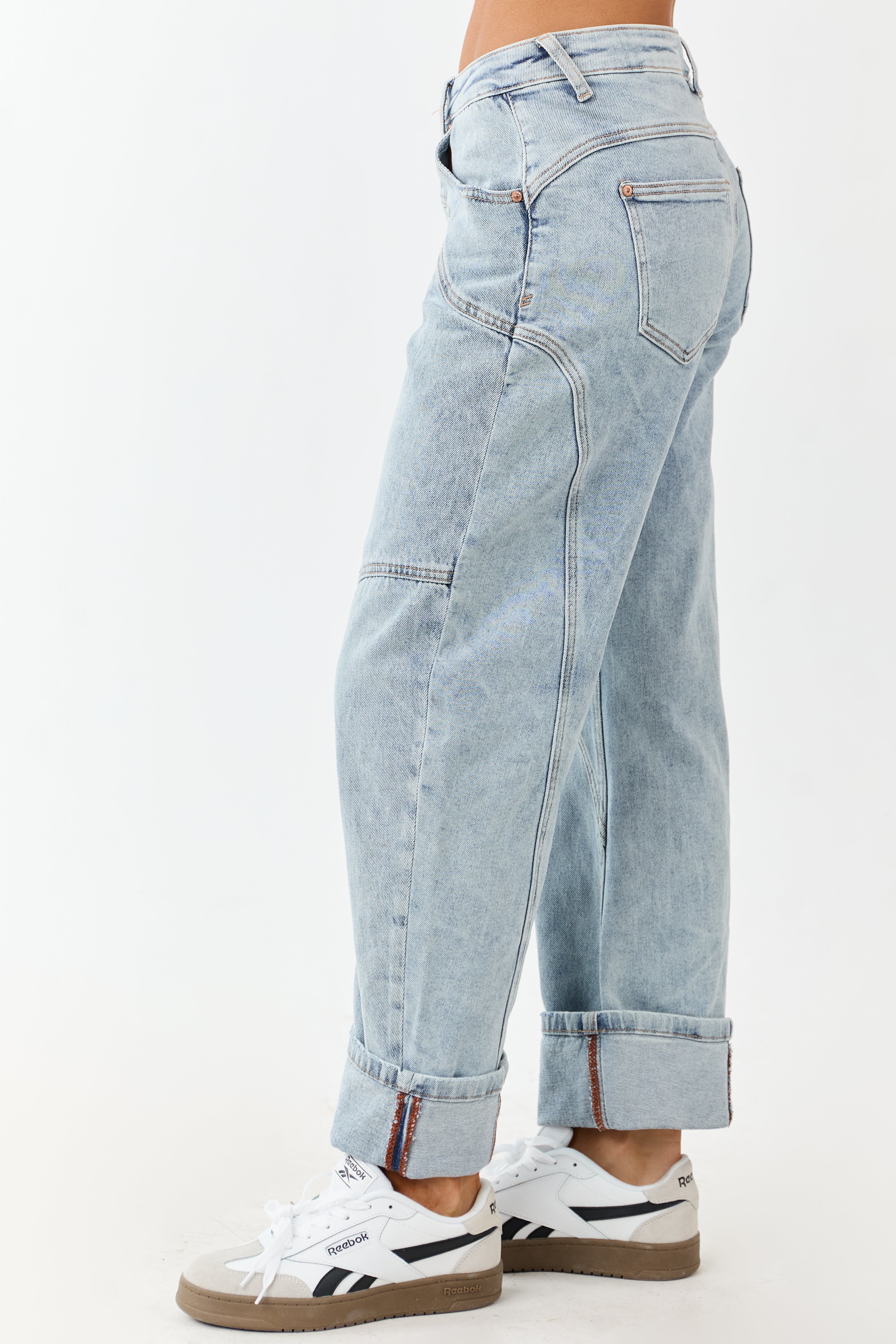 Light wash blue high-rise cuffed barrel baggy jeans with a relaxed fit. 2