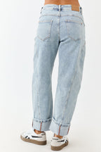 Light wash blue high-rise cuffed barrel baggy jeans with a relaxed fit. 3