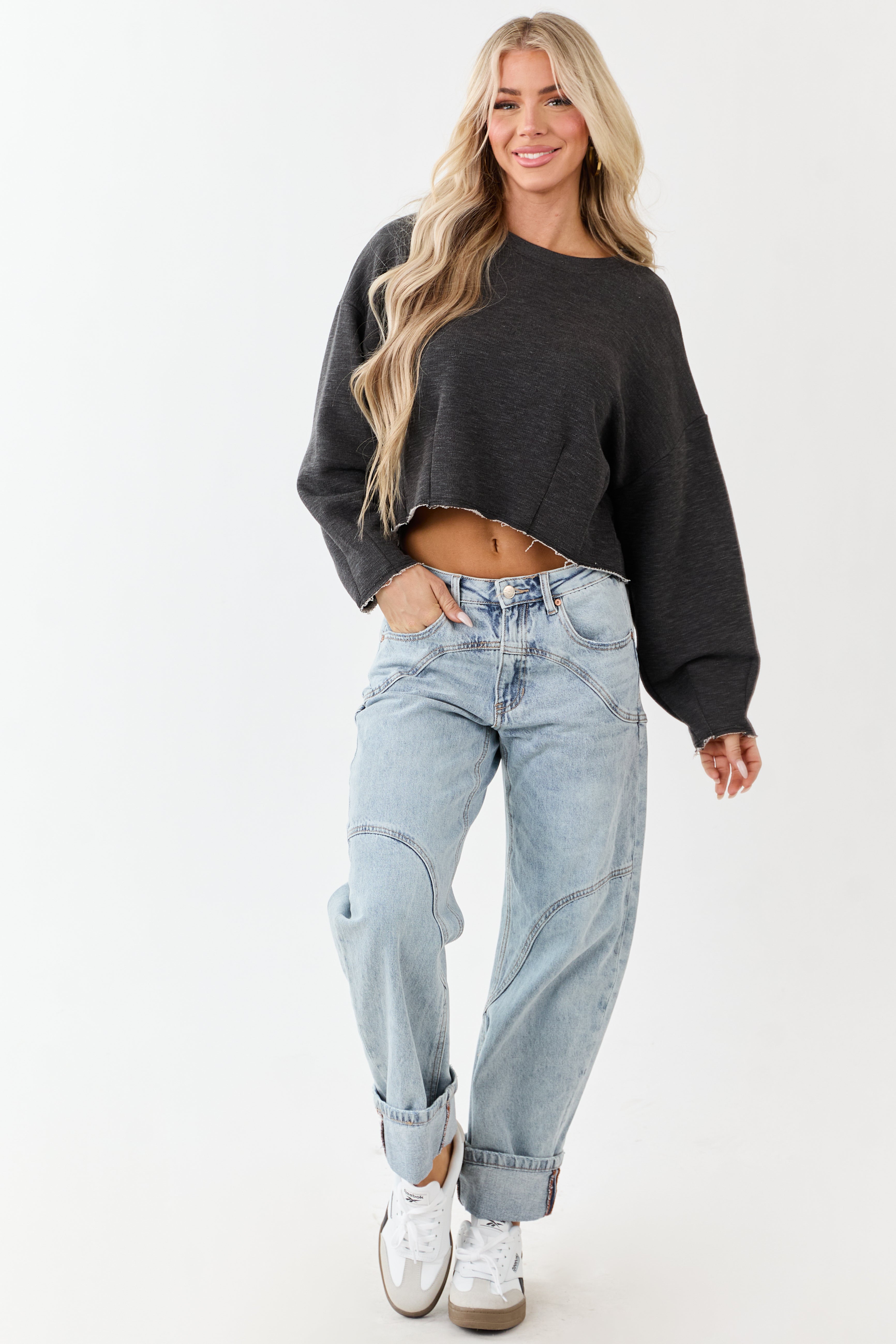 Light wash blue high-rise cuffed barrel baggy jeans with a relaxed fit. 4