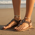 Beige bohemian flat sandals with an open vamp and colorful bead detail. 0