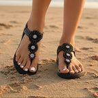 Beige bohemian flat sandals with an open vamp and colorful bead detail. 3
